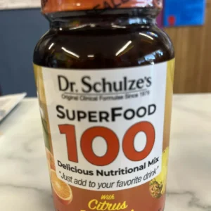 A 5.88 oz bottle of Dr. Schulze’s SuperFood 100 – Citrus & Pineapple sits on a countertop.