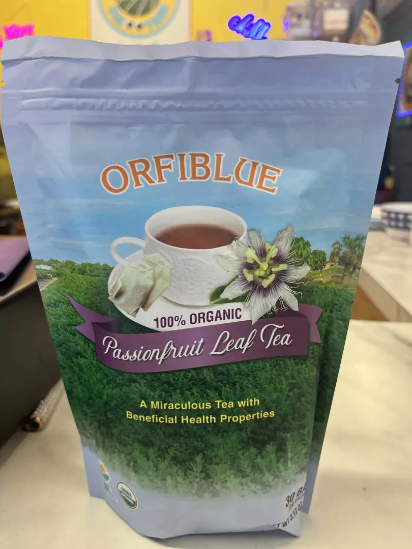 A package of Dr. Schulze's Teas 100% Organic Passionfruit Leaf Tea, showing a cup of tea, passionfruit flower, and text highlighting its organic and vegan-friendly health benefits.