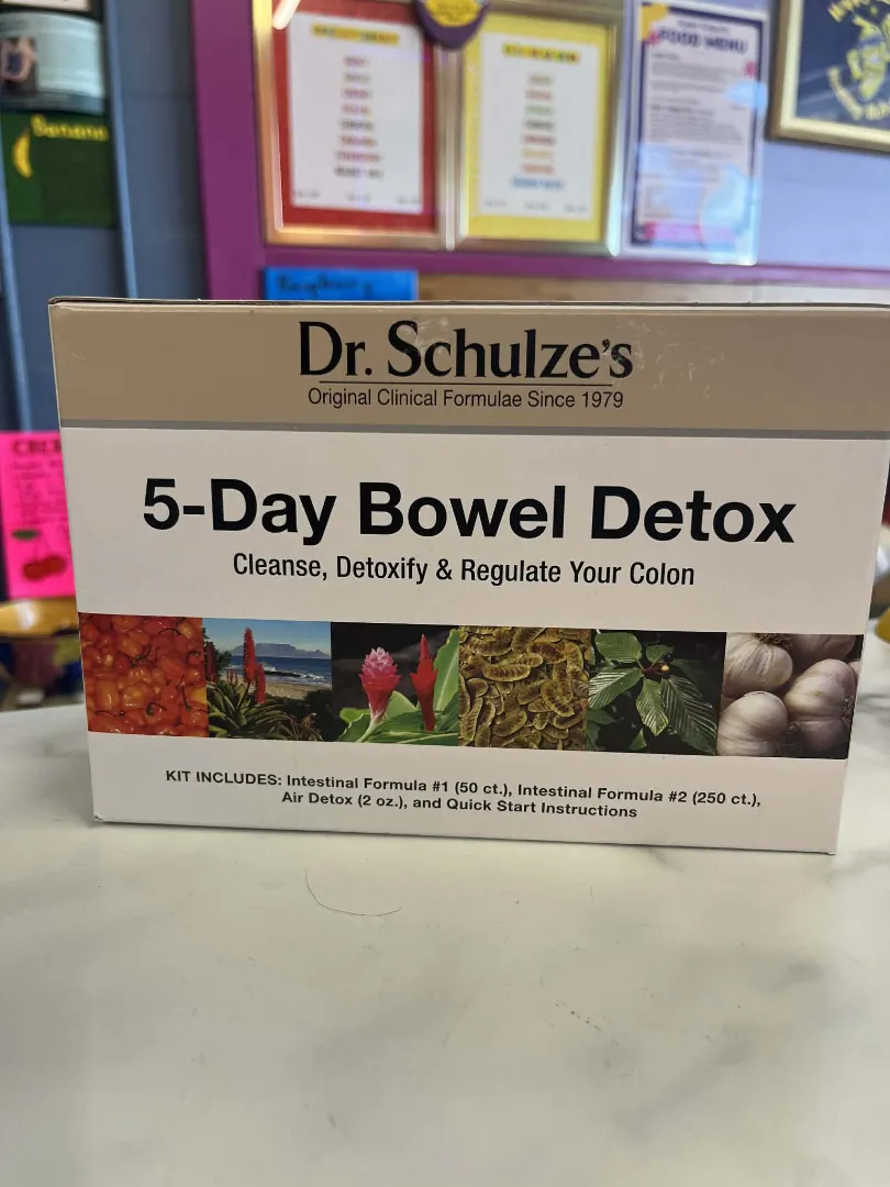 A box of Dr. Schulze's Bowel Detox, made with vegan and organic ingredients, sits on a counter with details and kit contents shown on the packaging.