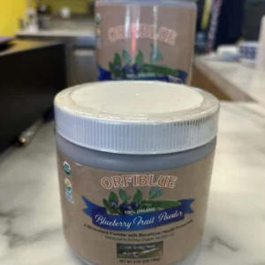 Two jars of Dr. Schulze's Tea Leaf Powder are displayed on a counter, with one jar in the foreground and one slightly blurred in the background. This vegan-friendly powder is perfect for healthy lifestyles.